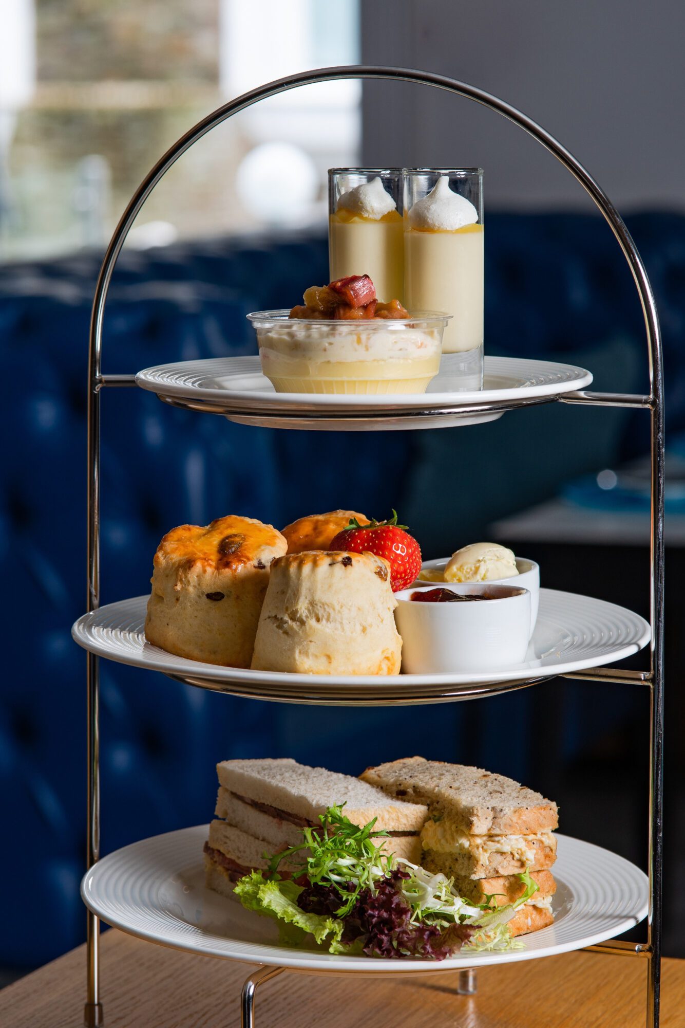 Afternoon tea stand three layers, scones, sandwiches, mini desserts