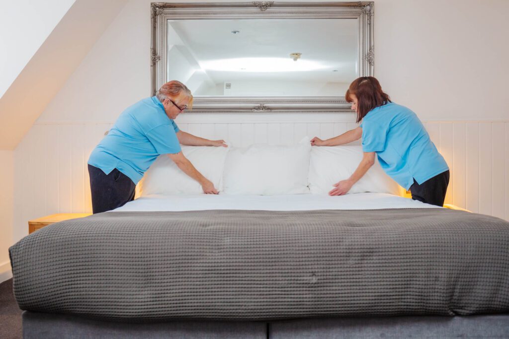 two women from the house keeping staff at The Carlton Hotel in lfracombe make the bed in one of the rooms
