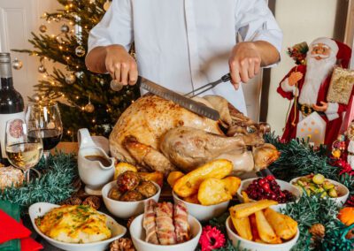 A chef cuts a large turkey at a Festive Christmas work party in North Devon