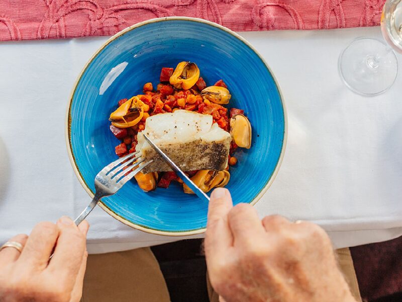 Cod broth diner hands overhead