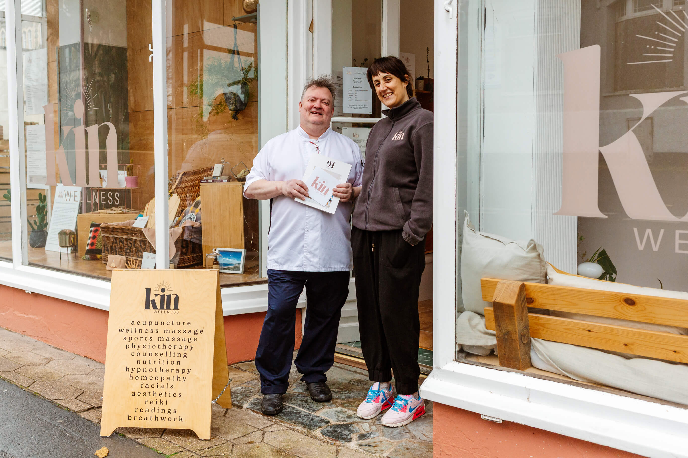 Eliot Seaborn-Wren stood outside of Kin Wellness with the owner in Ilfracombe